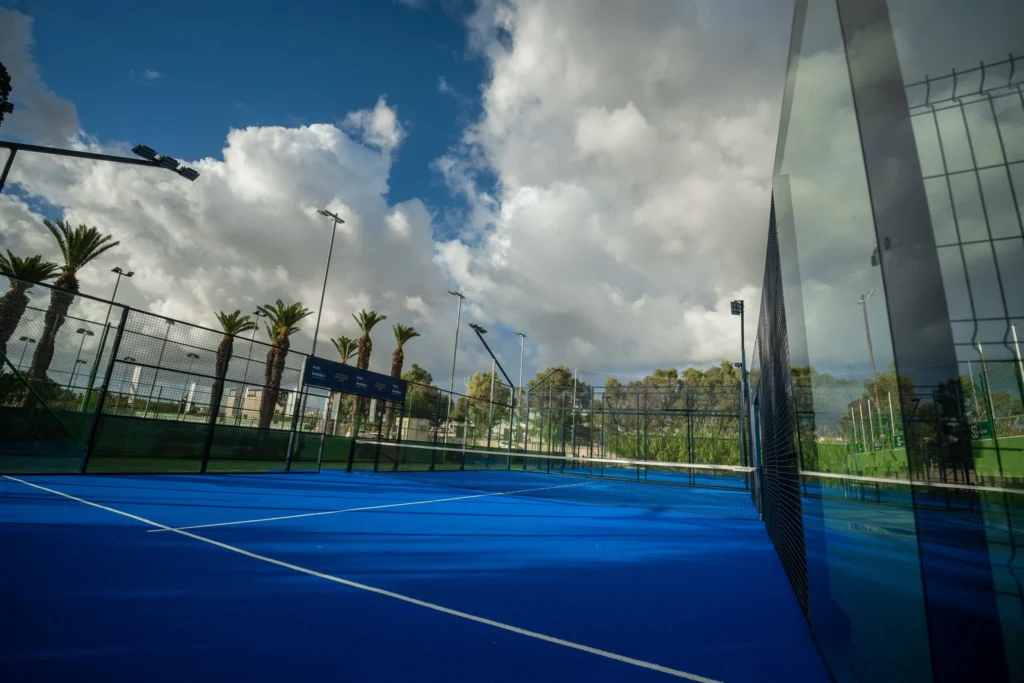 Blue padel court at the Marsa Sports club on a cloudy day